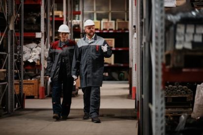 What are the 5 principles of Kaizen ? are wondering 2 factory workers walking in the shop floor