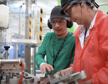 Two manufacturing colleagues implementing corrective actions after kaizen event.