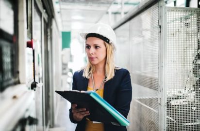 A woman is performing a A3 Problem Solving method in a factory
