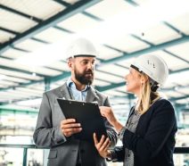 Un responsable de production rédige une charte de projet avec un manager