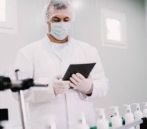 medical device manufacturer on factory floor using digital daily management system with ipad for tier meetings, escalations, gemba walks and more.