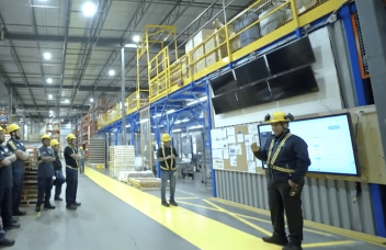 Manufacturing team practicing Kaizen culture during a daily shop floor huddle