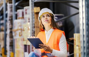 Quality control engineer inspecting parts on a manufacturing production line to reduce cost of poor quality