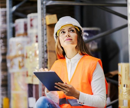 Quality control engineer inspecting parts on a manufacturing production line to reduce cost of poor quality