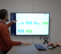 Manufacturers performing a digital daily huddle meeting as part of their lean daily management system.