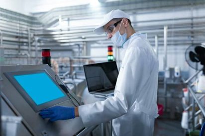 young manufacturing employee on shop floor with digital tools
